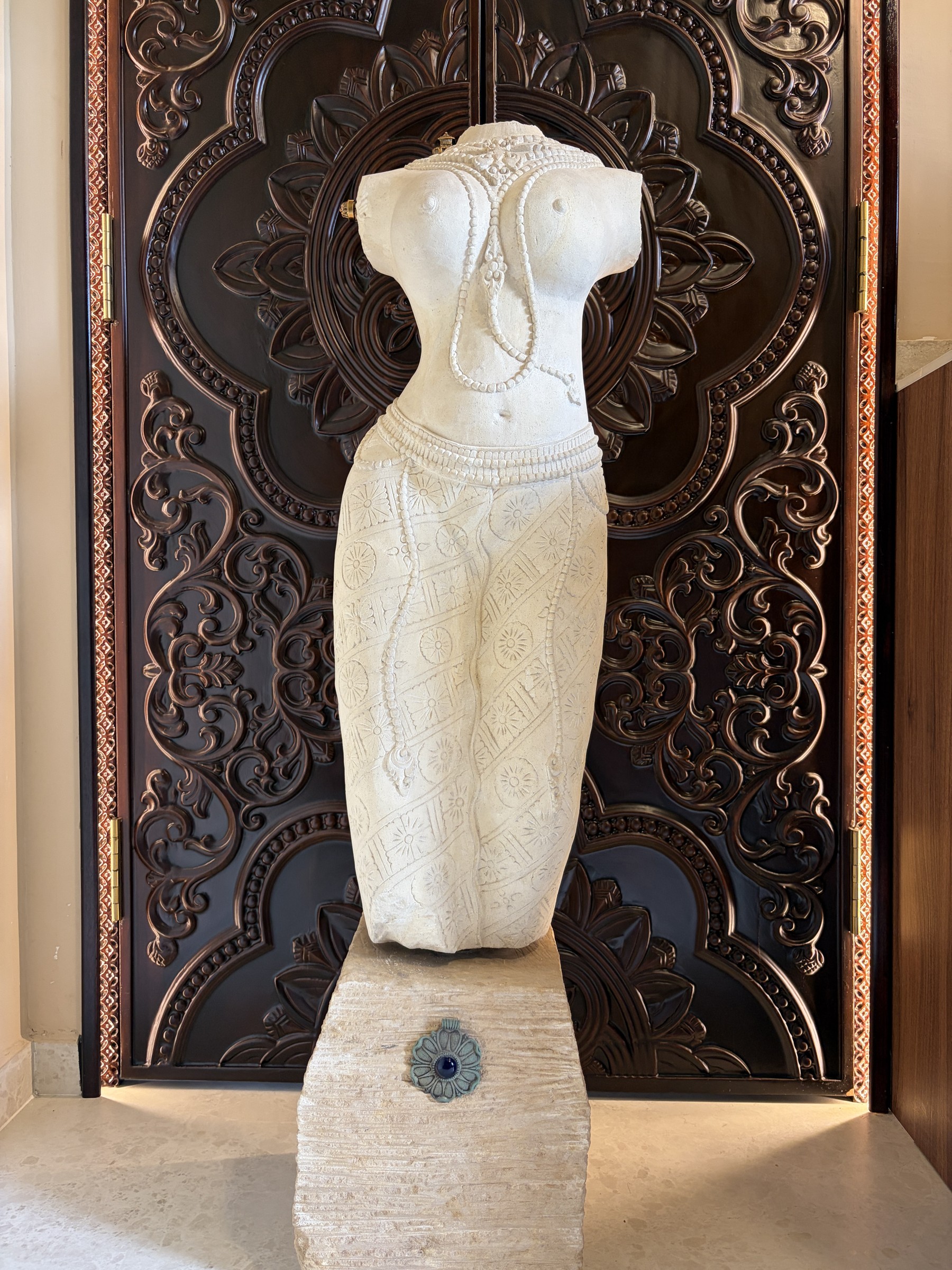 Carved Stone Torso of a Woman in a Sarong